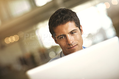 Buy stock photo Cropped shot of a businessman using his laptop in the office