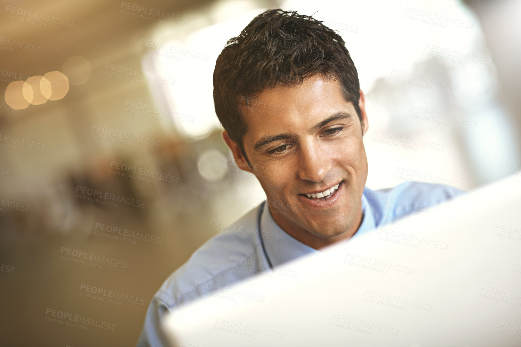 Buy stock photo Computer, face and blurred background with a business man at work on a project in his office. Smile, internet and technology with a young male employee working on a desktop for a company report