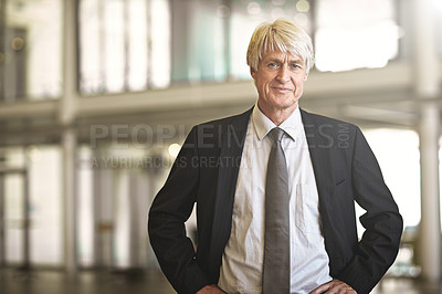 Buy stock photo Cropped portrait of a senior businessman standing with his hands on his hips