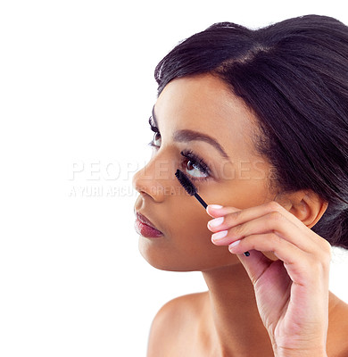 Buy stock photo Closeup studio shot of a young woman applying mascara