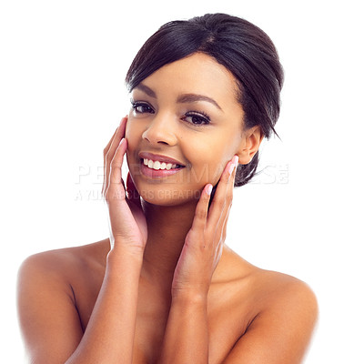 Buy stock photo Studio portrait of a young woman touching her perfect skin against a white background