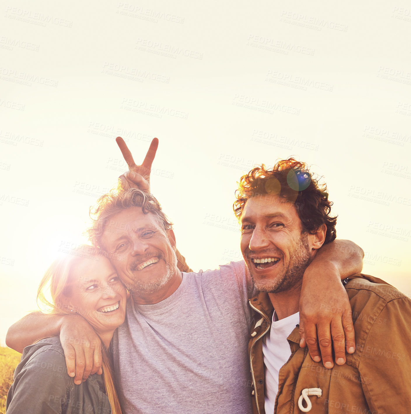 Buy stock photo Sunset, bunny ears and senior parent with children for adventure, hiking and walking outdoors. Family, travel and mature father with man and woman embrace on holiday, vacation and weekend together