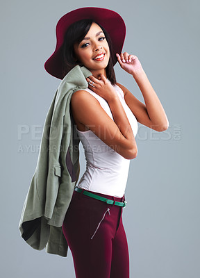 Buy stock photo Fashion, happy and portrait of woman in studio with trendy clothes, stylish and elegant outfit. Confident, attractive and isolated person with pride in style, hat and accessory on gray background
