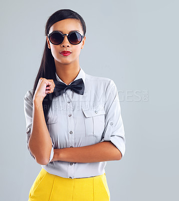 Buy stock photo Cropped portrait of a trendy young woman wearing shades against a gray background