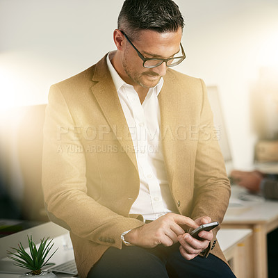 Buy stock photo Shot of a designer using his cellphone at the office