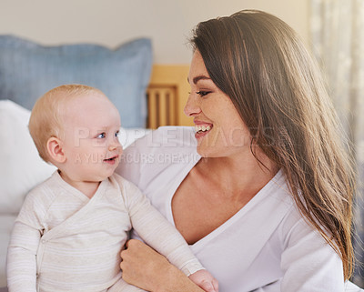 Buy stock photo Mother, baby and smiling together or embracing daughter and having fun in the bedroom feeling happy. Parent, kid and mom bonding or carefree and excited together in the house or parenthood 