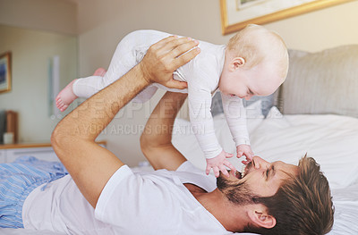 Buy stock photo Father, on bed and play with baby girl up in the air or flying daughter and having fun in the bedroom feeling happy. Parent, kid and dad bonding or carefree and excited together in the house