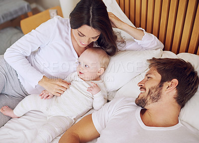 Buy stock photo Top view of mom, dad and baby on bed for love, care and quality time together at home. Happy parents, family and newborn kid relax in bedroom with support, childhood development and smile for bonding