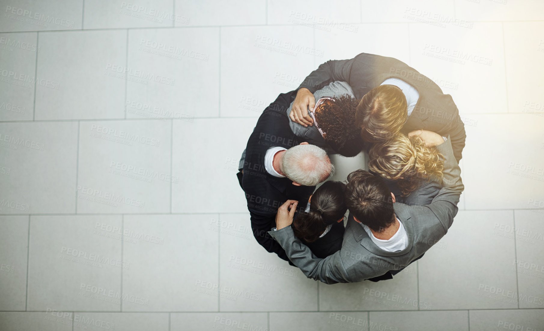 Buy stock photo High angle shot of a group of businesspeople standing in a huddle