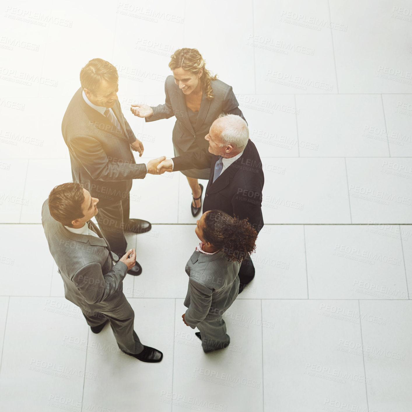 Buy stock photo Top view, handshake and group of business people in meeting for deal, agreement or crm on mockup. Above, shaking hands and employees with b2b collaboration, partnership and welcome to company office.