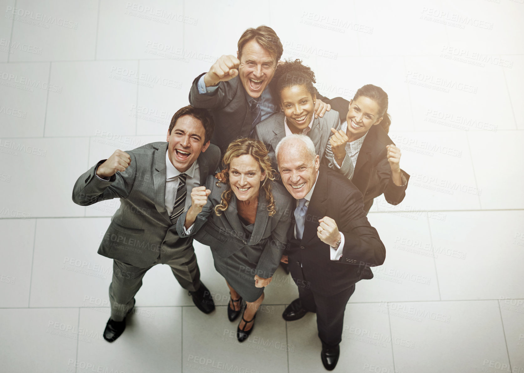 Buy stock photo High angle portrait of a group of businesspeople cheering in the office lobby