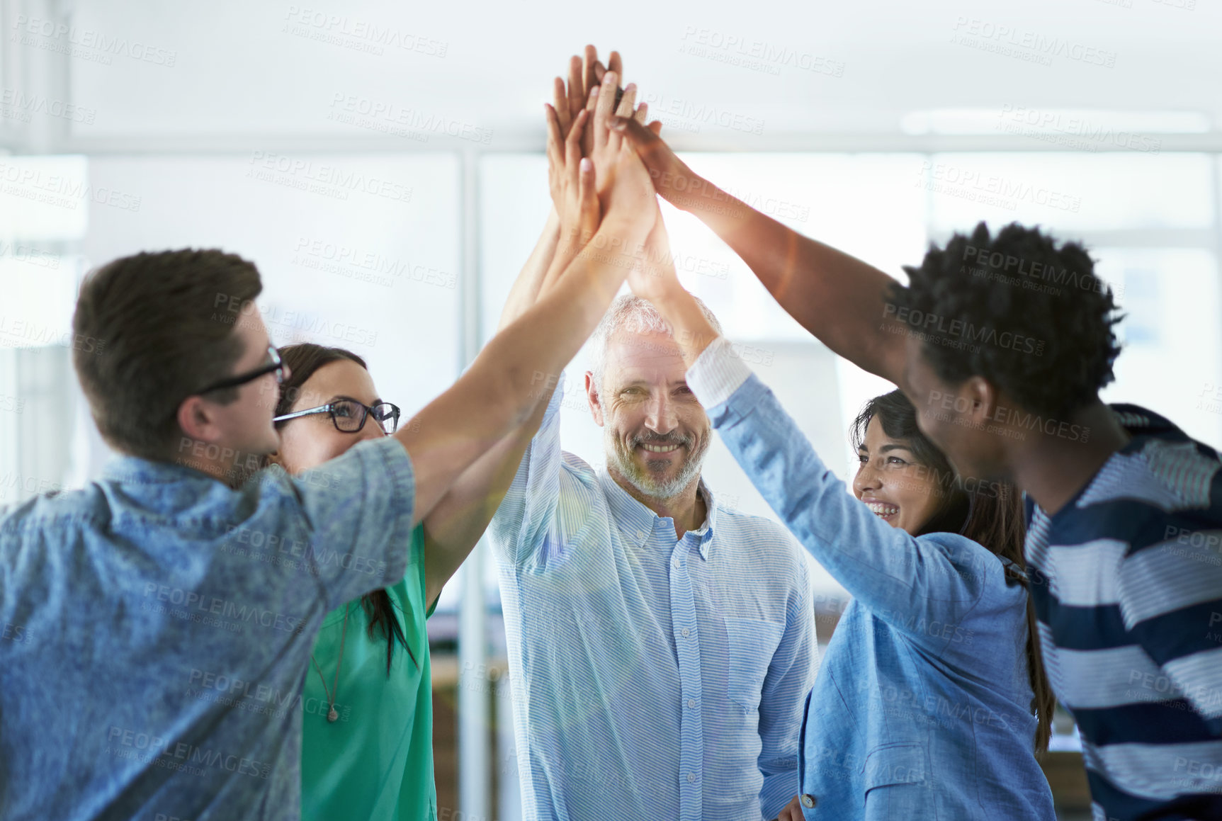 Buy stock photo Cropped shot of a group of businesspeople high fiving
