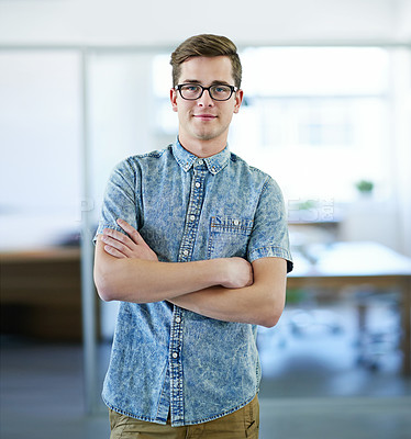 Buy stock photo Cropped portrait of a handsome businessman standing in the office with his arms folded