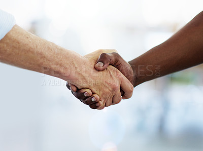 Buy stock photo Cropped shot of two unrecognizable businessmen shaking hands