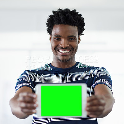 Buy stock photo Cropped portrait of a young businessman showing you a tablet while standing in the office corridor