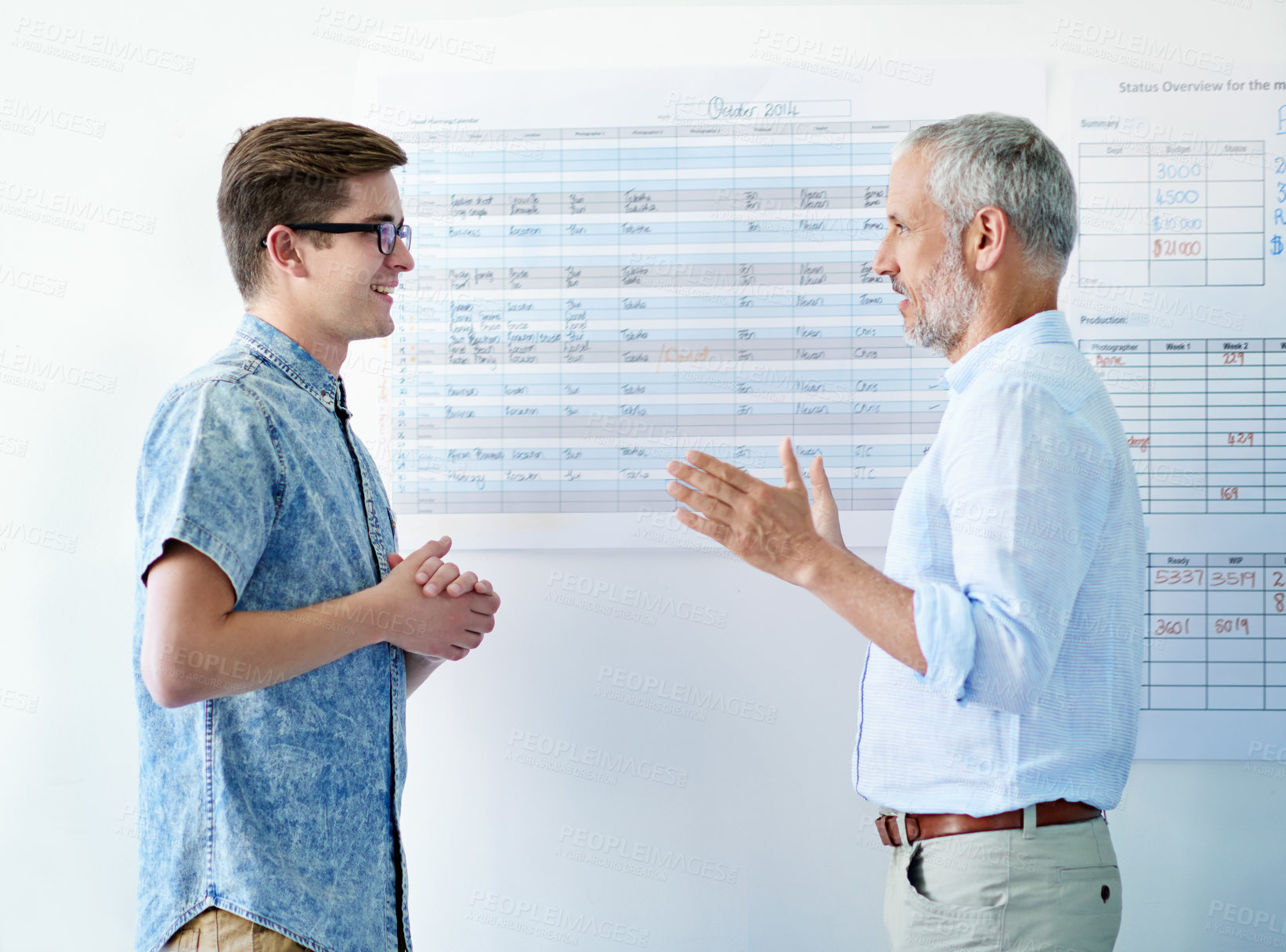 Buy stock photo Cropped shot of two businessmen talking in the office corridor