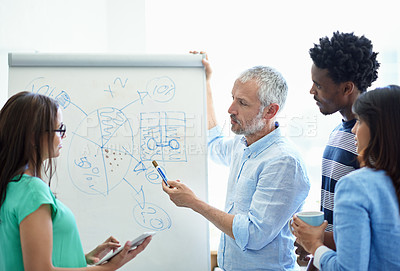 Buy stock photo Cropped shot of a mature businessman meeting with his creative team