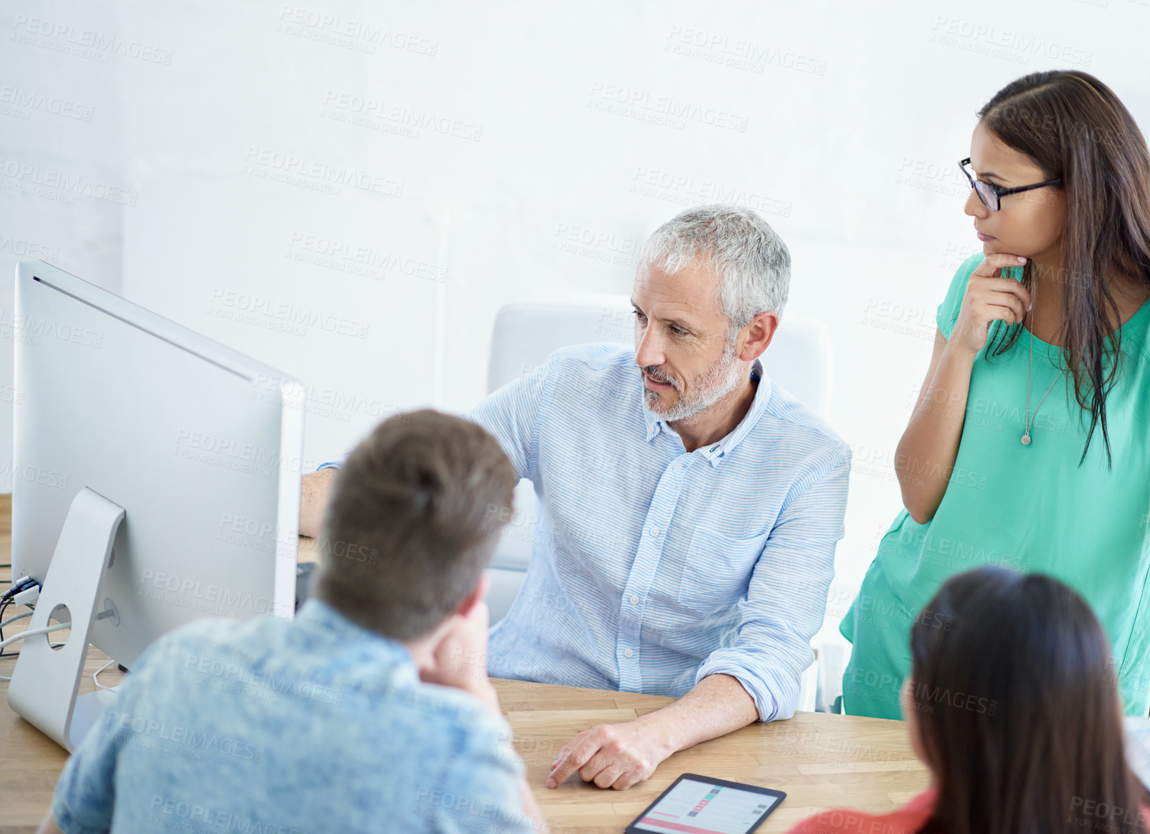 Buy stock photo Cropped shot of a mature businessman meeting with his creative team