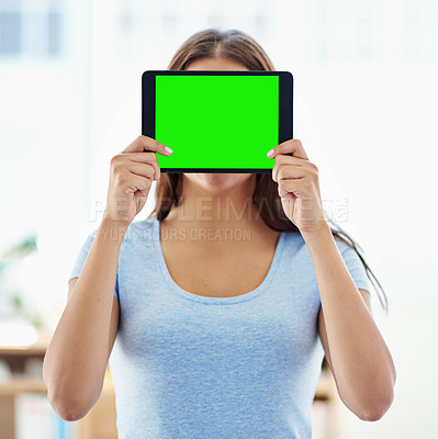 Buy stock photo Shot of a woman holding a digital tablet with a chroma key screen in front of her face