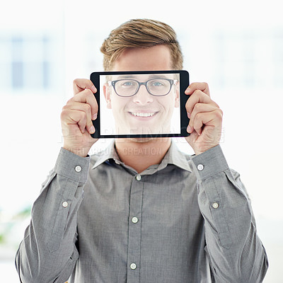 Buy stock photo A young man holding a digital tablet with a transparent screen in front of his face