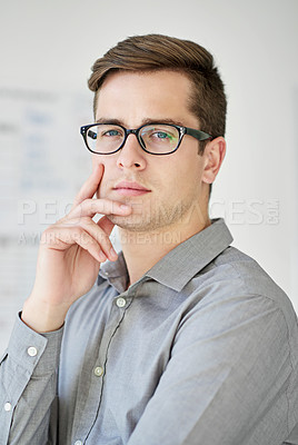 Buy stock photo Cropped shot of a serious young businessman in his office