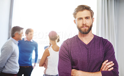 Buy stock photo Portrait of a young businessman with his colleagues standing in the background