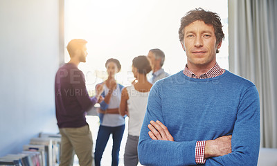Buy stock photo Portrait of a businessman with his colleagues standing in the background