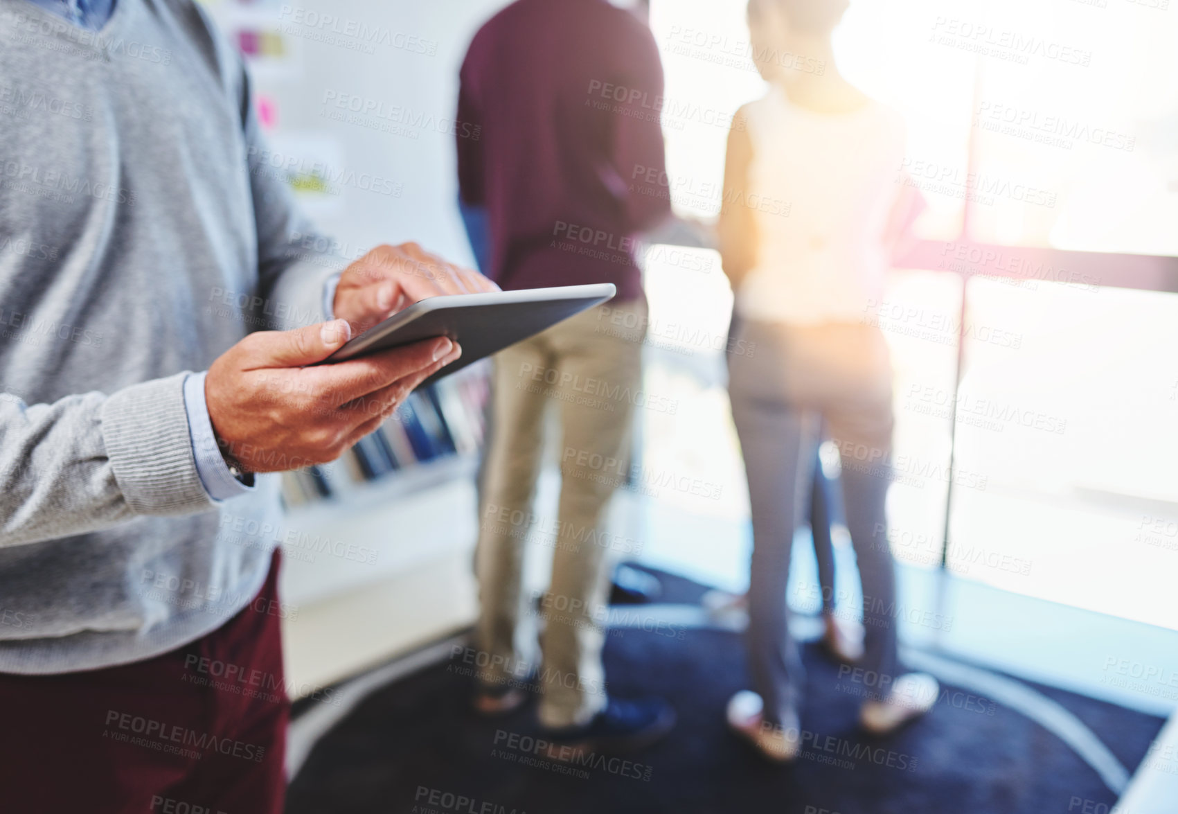 Buy stock photo Cropped shot of a businessman using a digital tablet at the office