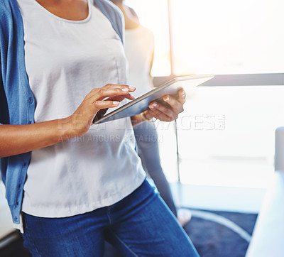 Buy stock photo Cropped shot of a businesswoman using a digital tablet at the office