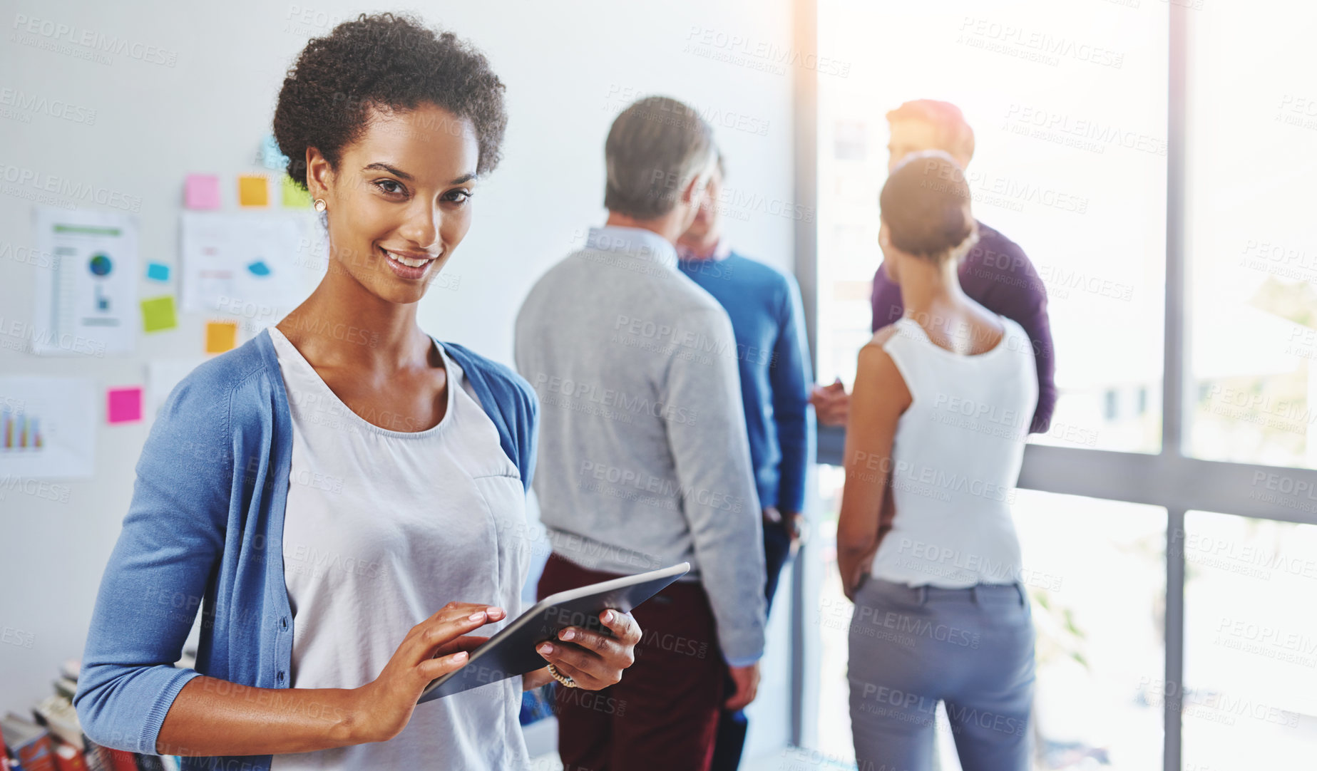 Buy stock photo Shot of a young businesswoman using a digital tablet in an office setting