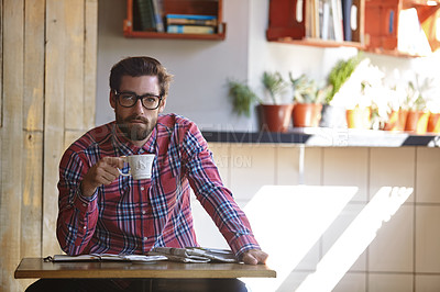 Buy stock photo Shot of a young man having coffee in a cafe