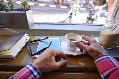 Buy stock photo Cropped shot of man with a tablet, diary and coffee cup at a cafe counter