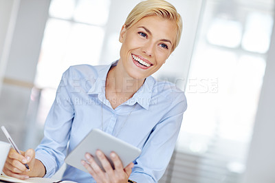 Buy stock photo Cropped shot of a young businsswoman using a digital tablet at her desk in the office