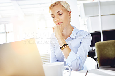 Buy stock photo Cropped shot of a young businesswoman using a laptop at her desk
