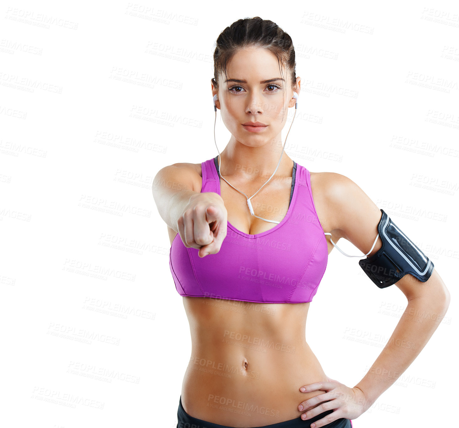 Buy stock photo A fit young woman pointing towards you while wearing an mp3 arm band isolated on white