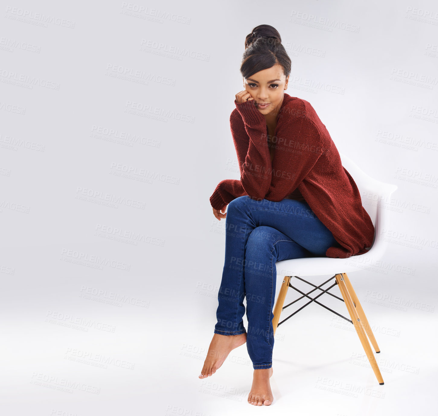 Buy stock photo Studio portrait of an attractive young woman sitting on a chair