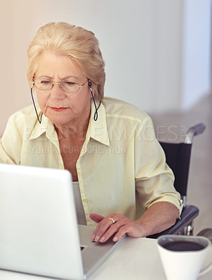 Buy stock photo Cropped shot of a senior woman using her laptop at home