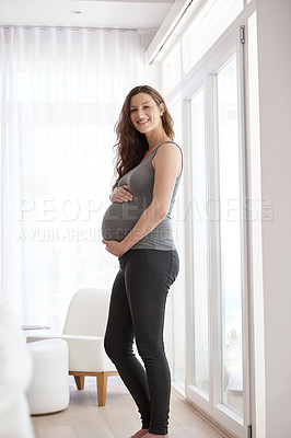 Buy stock photo Cropped portrait of a young pregnant woman standing in her home