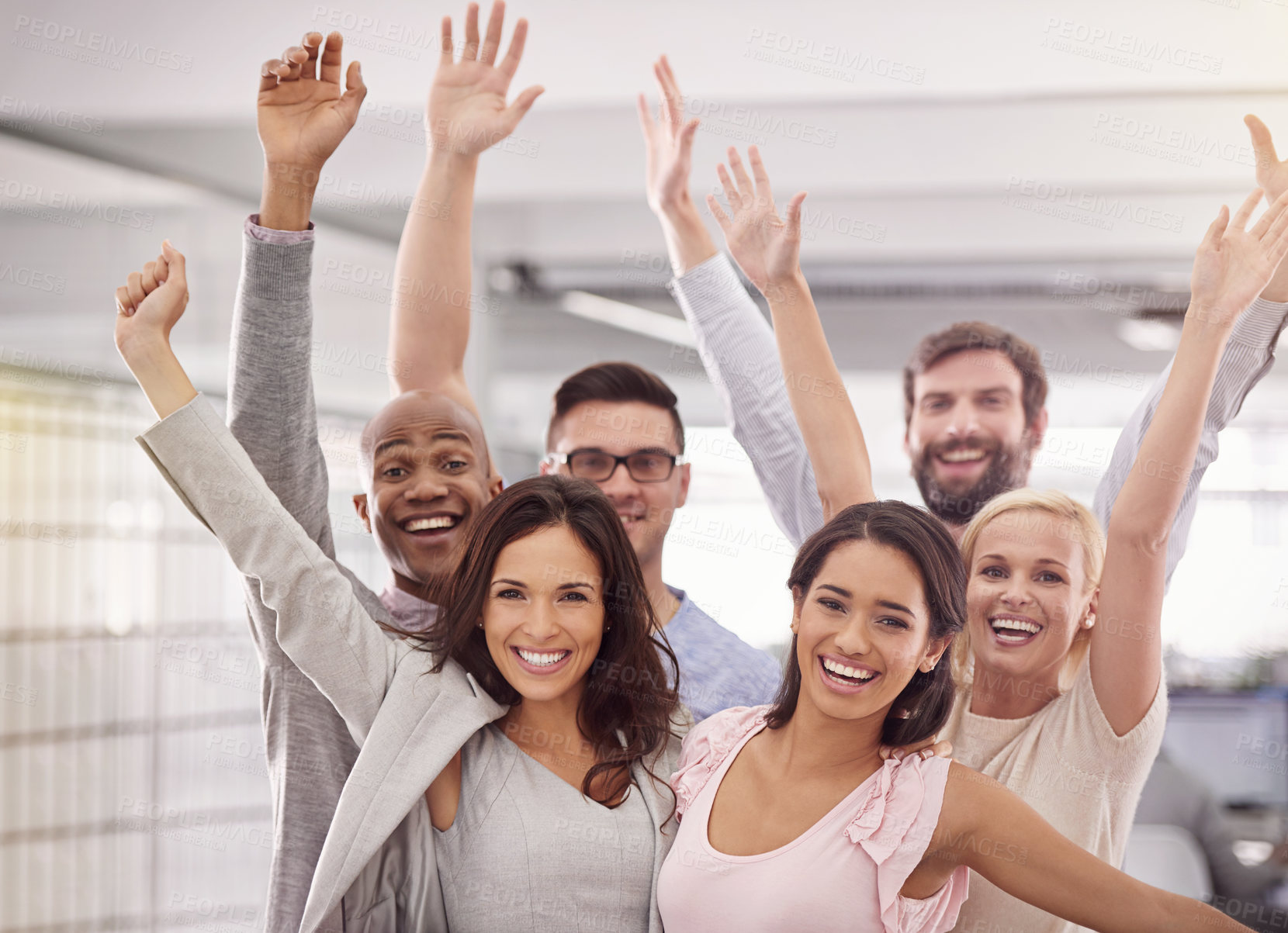 Buy stock photo Cropped portrait of an enthusiastic business team standing with their arms raised