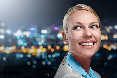 Buy stock photo Cropped shot of a businesswoman standing against a cityscape at night