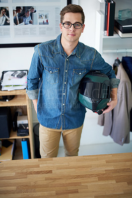 Buy stock photo Portrait of a young male designer holding his helmet while standing in the office