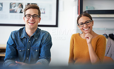 Buy stock photo Cropped shot of two coworkers sitting beside each other in the office