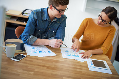 Buy stock photo Shot of two colleagues working together on a creative project
