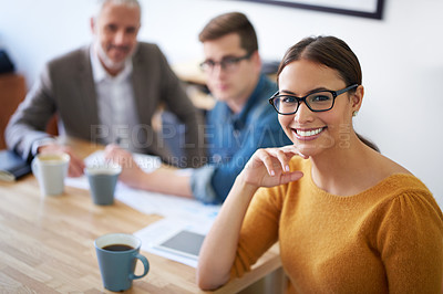 Buy stock photo Portrait of a young businesswoman with her colleagues working in the background