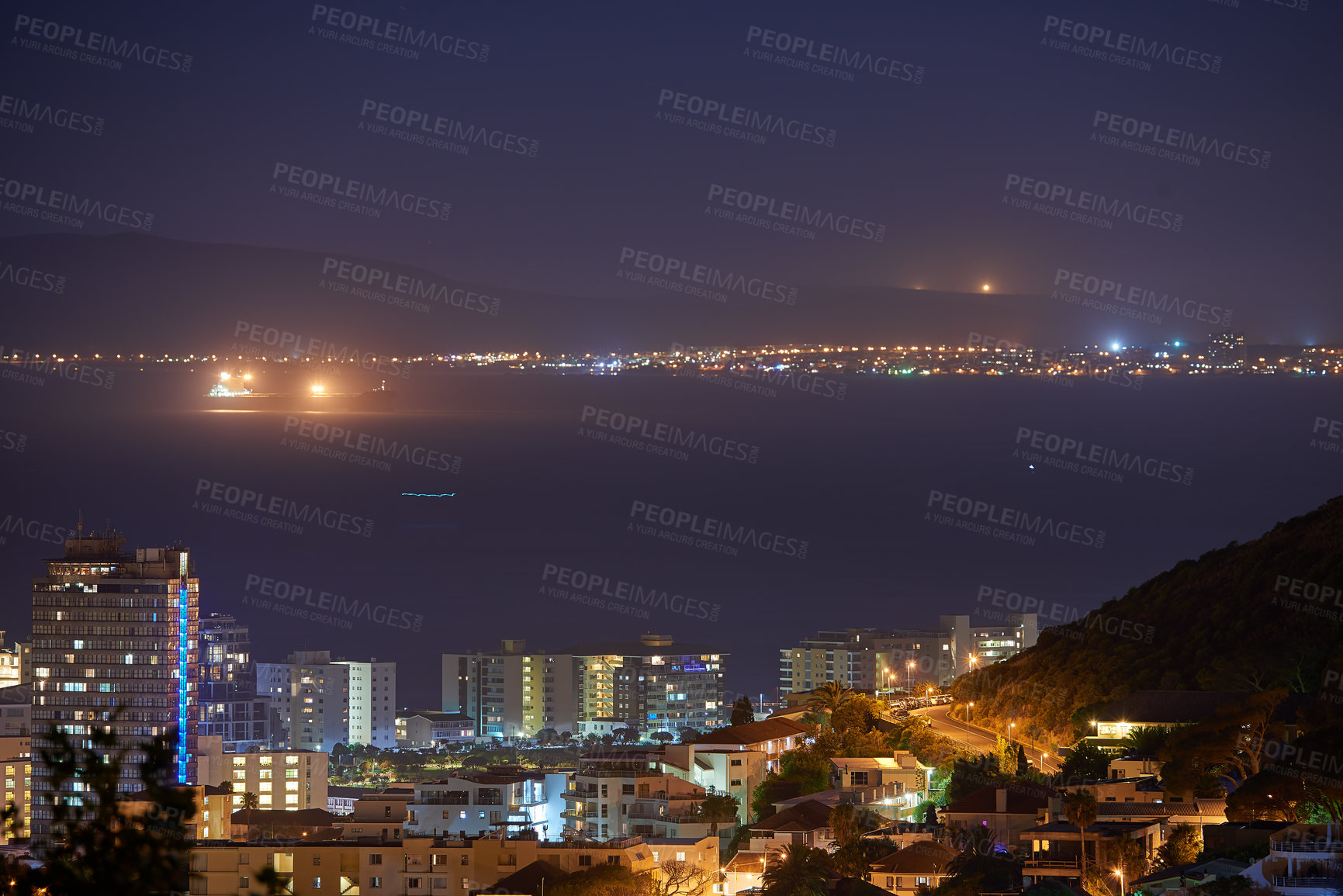 Buy stock photo Night, lights and skyline with buildings by ocean for travel, urban adventure and aerial view of harbour. Dark, cityscape and landscape of sea for vacation, port and residential area in South Africa