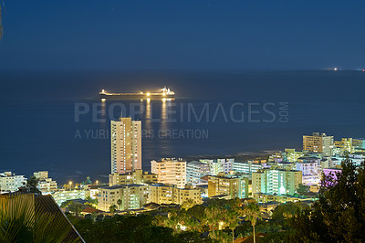 Buy stock photo Buildings, night and architecture or cityscape and ocean for travel, skyline or urban development. Lights, skyscraper and hospitality or hotel, horizon and landscape in Los Angeles with nature or sea