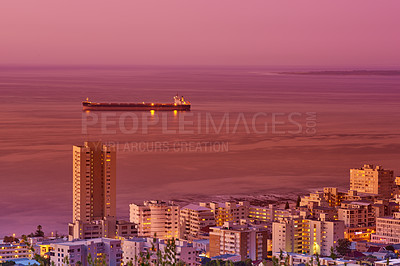 Buy stock photo Cityscape, sunset and ocean or urban landscape with buildings, boat and sea or outdoor. Development, skyline and port or dock for shipping, cargo and tourism or travel for architecture or hospitality