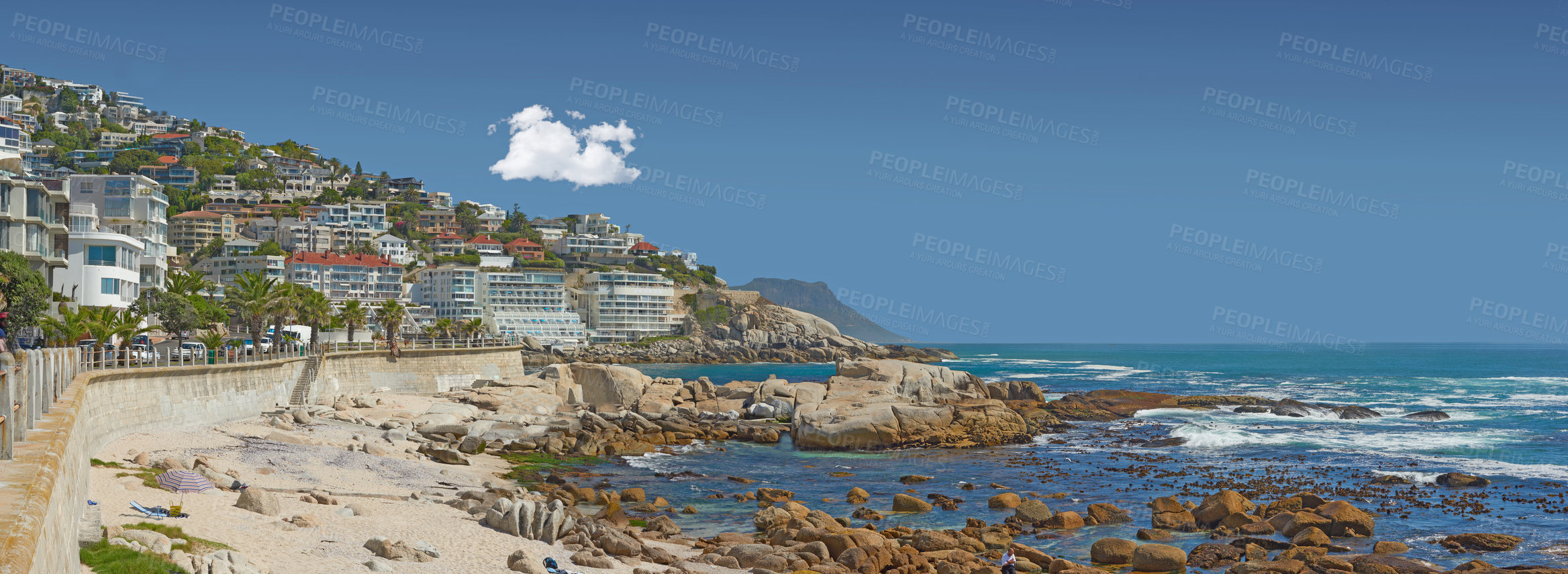 Buy stock photo Landscape, beach and beachfront for travel, holiday and nature with buildings, ocean and sunshine. Coastal view, water and sea in summer for tropical vacation in Cape Town with blue sky and cityscape