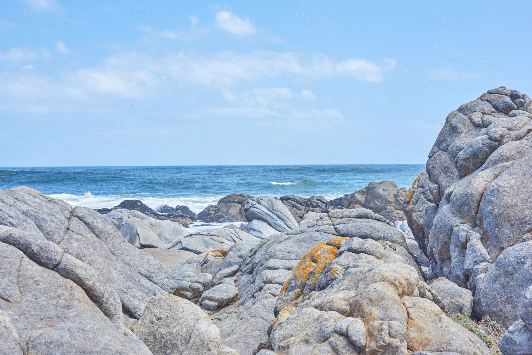 Buy stock photo Nature, blue sky and sea with coastal rocks for outdoor adventure, peace and horizon by water. Natural environment, landscape and ocean boulders for travel, panoramic view and calm in South Africa