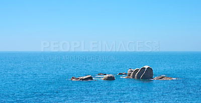 Buy stock photo Ocean, rocks and travel in outdoor nature, destination and peace in environment on sea vacation. Water, stone and calm beach on weekend trip, tropical island and holiday wallpaper of Bali skyline